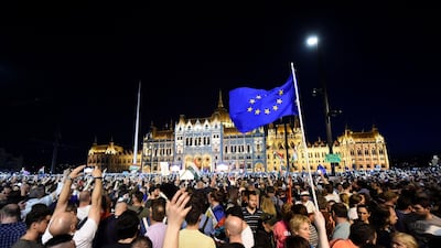 People protest against the policies of Hungarian Prime Minister Viktor Orban's government in last weekend's general election in front of the Parliament in Budapest, Hungary. Attila Kisbenedek / AFP