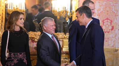 King Abdullah II shakes hands with Spain's Prime Minister Pedro Sanchez alongside Jordan's Queen Rania. AP