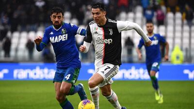 Sassuolo's Italian midfielder Francesco Magnanelli (R) fights for the ball with Juventus' Portuguese forward Cristiano Ronaldo. AFP