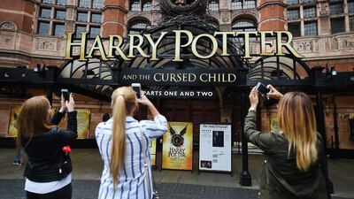 Harry Potter fans use mobile phones to photograph the Palace Theatre in London. EPA