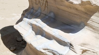 Graffiti vandalism near the entrance of the ancient rock formations attraction in the outskirts desert area, at Al Wathba. Khushnum Bhandari / The National
