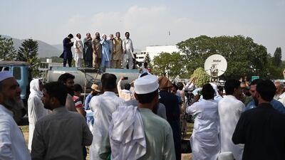 Workers protest in front of the parliament in Islamabad during the annual budget session, demanding an increase in salaries. AFP