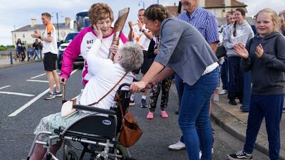 Jean Dixon is greeted by her mother, Jean Buck, 98, after she carried the baton through Seaham. Getty Images