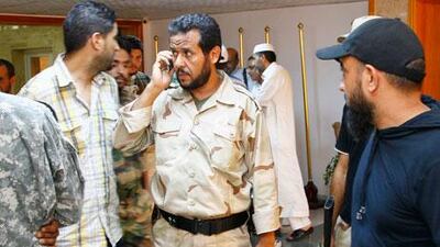 Abdel Hakim Belhaj, centre, is seen as a rebel military commander during the Libyan uprising in 2011. Belhaj and his wife are suing the British government, the former foreign secretary Jack Straw and the former head of the MI6 spy agency, Mark Allen. FRANCOIS MORI/AP
