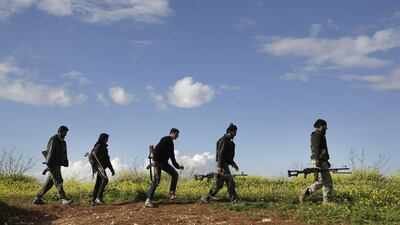 Rebel fighters from the Ahrar Al Sham Islamic Movement carry their weapons as they move towards their positions near Morek frontline in the northern countryside of Hama on March 16, 2015. Khalil Ashawi/Reuters