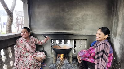 Amandeep Kaur and her neighbour Harvinder Kaur cook a seasonal dessert on a clay stove for the festival of Lohri.