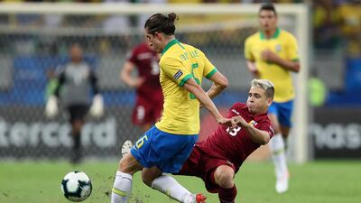 Venezuela's Yeferson Soteldo, right, vies for the ball against Brazil's Filipe Luis. AP Photo