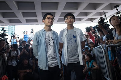 Pro-democracy activists Nathan Law, left, and Joshua Wong, right, were jailed last year for "unlawful assembly" in the protests. Vernon Yuen / EPA
