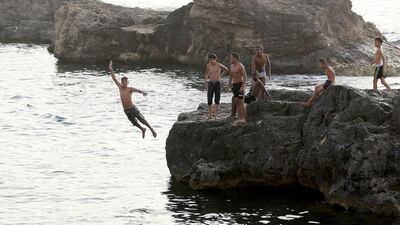 Libyan youths cool off at the seaside in the Libyan capital, Tripoli. Mahmud Turkia / AFP