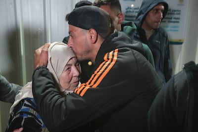A man embraces his mother as Palestinians arrive at Nasser Hospital in Khan Younis, southern Gaza, after returning through the Rafah crossing. Reuters
