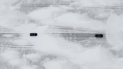 Motorists drive on the unofficial ice road between the mainland and Vormsi island in Estonia, amid low water levels that enable the freezing of the Baltic Sea. Reuters
