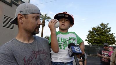 Jeremy, carried by family friend Jason Anderson, arrives to help hero cat Tara throw the pitch, which was tied to a fishing line.