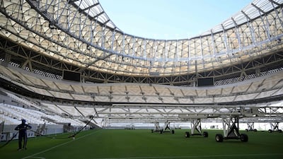 A man works on the pitch of the Lusail Stadium in Doha. AFP