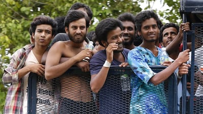 Migrants on a truck as they are transferred from a temporary detention facility to a naval base on Langkawi island, Malaysia, on May 13, before being moved to a detention center on the Malaysian mainland. Vincent Thian/ AP Photo