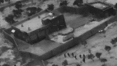 This image from video released by the Department of Defense shows US Special Forces, figures at lower right, moving towards the compound of ISIS leader Abu Bakr Al Baghdadi. AP