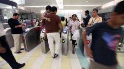 People enter and exit the Union Metro station in Dubai on Saturday.