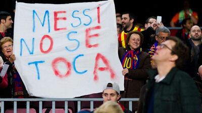 Barcelona supporters display a sign in support of Lionel Messi before Barca's La Liga match against Atletico Madrid on Sunday at the Camp Nou. Alex Caparros / Getty Images