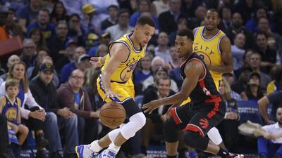 Golden State Warriors' Stephen Curry, left, drives the ball against Toronto Raptors' Kyle Lowry. Ben Margot / AP Photo