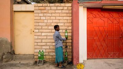 Mohammed Safiola, from Bangladesh, fills bottles with drinking water from the public tap supplied by an Emirati resident in the old neighbourhood of Al Rams. Water at Mohammed’s accommodation is of low quality.