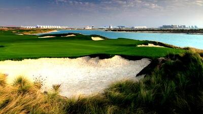 A view from behind the green on the par-4, 3rd hole looking back towards the clubhouse and the Yas Island Formula 1 racetrack at Yas Island Golf Club designed by Kyle Phillips in Abu Dhabi. Photo by David Cannon / Getty Images