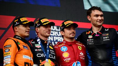 Red Bull's Max Verstappen celebrates on the podium alongside with second-placed Lando Norris of McLaren and third-placed Charles Leclerc of Ferrari. Reuters