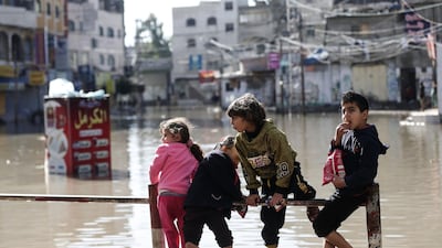 Palestinian children play on a flooded street following heavy rains in Jabalia refugee camp in northern Gaza strip. AFP