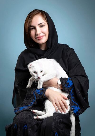 Manal Al Mansoori helps to feed stray cats in Dubai. Courtesy: Yanni Animal Welfare