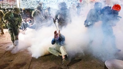 Federal officers use chemical irritants and crowd control munitions to disperse Black Lives Matter protesters in Portland. AP