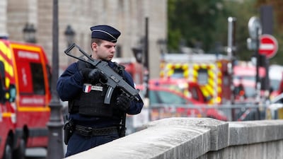 French police and security forces establish a security perimeter near the police headquarters where a man was attacking officers with a knife in Paris. EPA/IAN LANGSDON