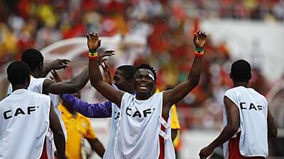 Ghana's substitutes, including Dominic Adiyiah, centre, celebrate on the sidelines after Gyan's winning goal yesterday.