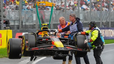 Track marshals remove Red Bull driver Liam Lawson's car after crashing. AP