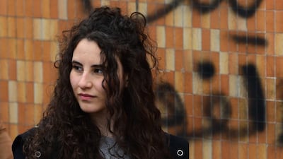 A female university student carries a crossed out picture of the newly appointed Iraqi Prime Minister Mohammed Allawi with a placards reading in Arabic 'My loyalty to Iraq', during a strike and protests in central Baghdad, Iraq. EPA