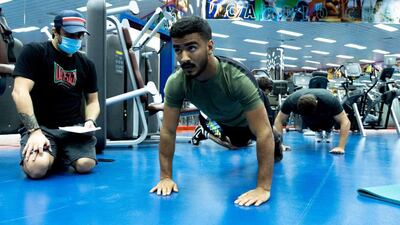 Hamad Nawad goes through his workout while being monitored by coach Ramon Lemos during the high performance camp at the Armed Forces Club in Abu Dhabi. Courtesy UAEJJF