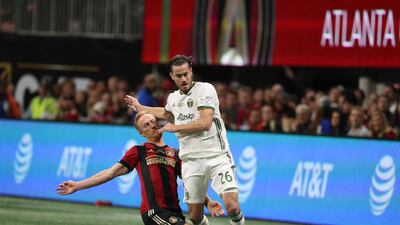 Portland Timbers' Lucas Melano and Atlanta United's Jeff Larentowicz compete for the ball. Reuters