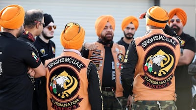 Gurnam Singh leads a briefing at an Enoc petrol station before the ride. Pawan Singh / The National