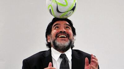 Diego Maradona, pictured during his meeting with Chinese Football Associations chief executive Wei Di in Beijing on August 16, 2012, needed a helping hand to escape a crowd of Brazilians during the opening match of the 2014 World Cup.