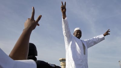 Gambian president Adama Barrow greets the crowds after arriving at Banjul airport in Gambia on January 26, 2017, after flying in from Dakar, Senegal. Jerome Delay / AP Photo