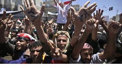 Anti-government protesters at a demonstration demanding the resignation of the Yemeni president, Ali Abdullah Saleh, in Sanaa. The Arabic on the demonstrator's hands reads "Leave".