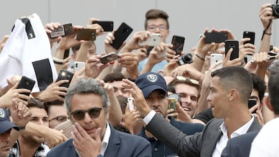 Ronaldo greets his supporters outside the Juventus medical center. AFP