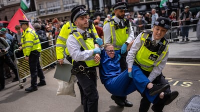 A woman is detained by police during protests after the Court of Appeal ruled in favour of the Home Office. Getty Images