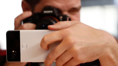 A man takes a photo of a Google Pixel 2 phone during a launch event last week in San Francisco, California. Stephen Lam/Reuters
