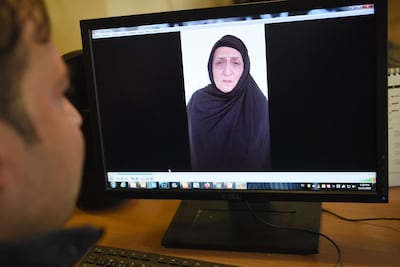 A man watches a video of Afghan woman Nasreen, who walked free from jail in September after confessing to being members of the Taliban's ultra-violent Haqqani network. AFP