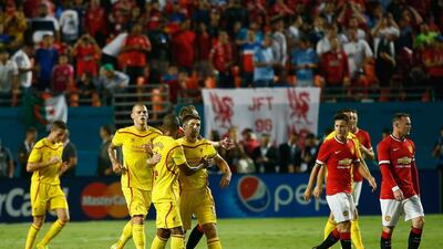 Steven Gerrard of Liverpool is congratulated by his teammates for scoring a penalty kick against Manchester United in the first half of the Guinness International Champions Cup 2014 Final at Sun Life Stadium on August 4, 2014 in Miami Gardens, Florida. Chris Trotman/Getty Images