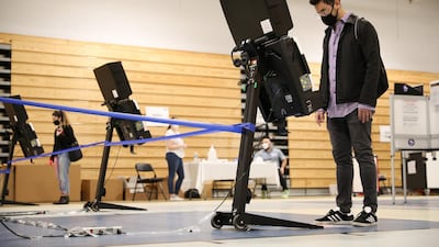 Julian Belilty, from the Kalorama neighbourhood of the District of Columbia, casts his early vote at the Marie Reed Elementary School in the Adams Morgan Neighborhood in Washington, U.S.. Reuters