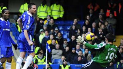 Frank Lampard chips the ball over the West Brom goalkeeper Scott Carson for Chelsea's second goal.