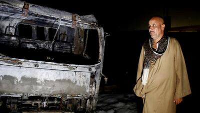 A man stands near burned vehicles following a fire that broke out in the Shuqair-Mostorod crude oil pipeline, on the Cairo-Ismailia road, in Egypt. A ruptured crude oil pipeline set off a monstrous blaze on a desert highway in Egypt on Tuesday, injuring at least 17 people, local authorities said. AP Photo