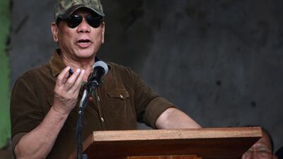 President Rodrigo Duterte gestures as he delivers his speech declaring Marawi "liberated" during a ceremony inside the battle area in Marawi on October 17, 2017. Ted Aljibe / AFP