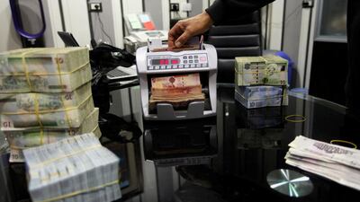 A currency counting machine counts Libyan dinars at a currency exchange office in Tripoli. Libya introduced a raft of measures Wednesday to boost its struggling economy. Reuters