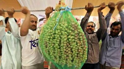 People arrive with their dates for scaling on the first day of the date festival.