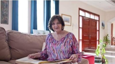 Caroline Bancroft looks through old photos of the UAE at her daughter's home in Umm Suqiem.